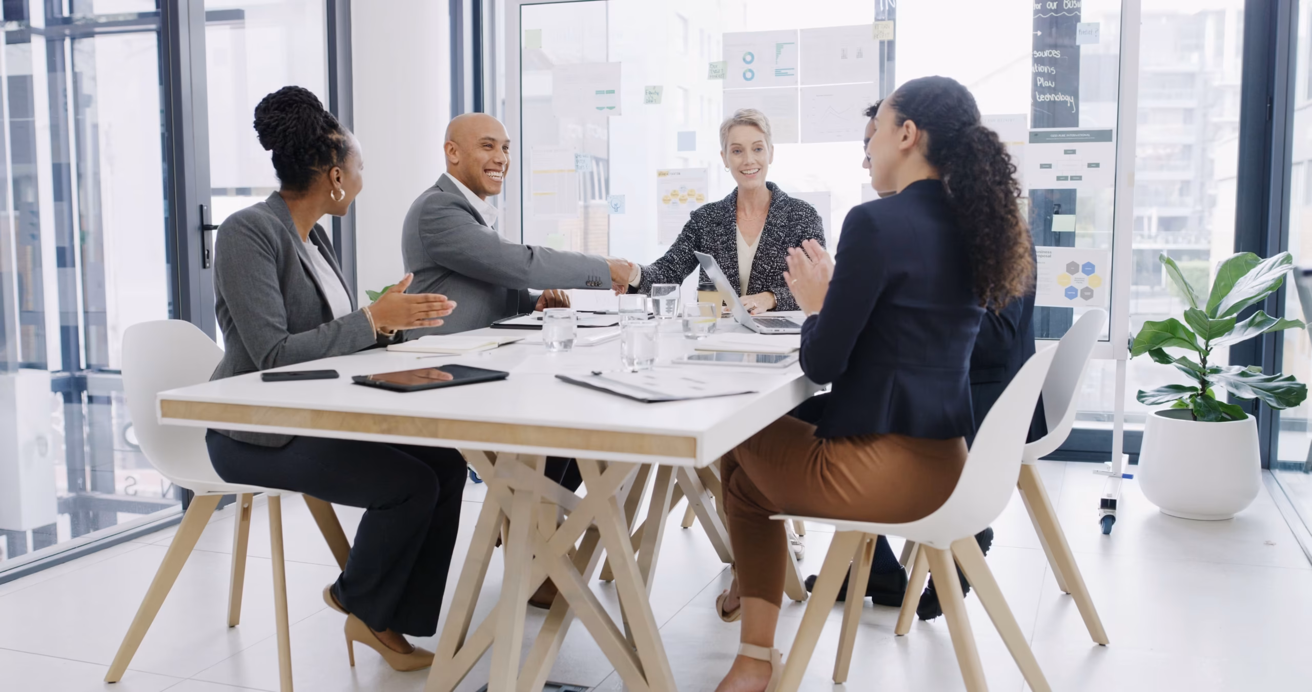 Business team shaking hands during a partnership meeting in a modern boardroom